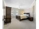 Well-appointed bedroom with plantation shutters and dark wood furniture at 4621 S Atlantic Ave # 7101, Ponce Inlet, FL 32127