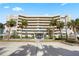 Stunning condo building featuring beautiful landscaping with palm trees and plenty of parking spaces at 4621 S Atlantic Ave # 7101, Ponce Inlet, FL 32127