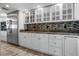 Bright kitchen featuring white cabinetry, mosaic backsplash, and stainless steel appliances at 4621 S Atlantic Ave # 7101, Ponce Inlet, FL 32127