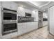 Beautiful kitchen featuring a double oven, stainless steel appliances, and white cabinetry at 4621 S Atlantic Ave # 7101, Ponce Inlet, FL 32127