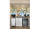 Close up view of the wet bar area featuring a mini fridge and a wine cooler at 4621 S Atlantic Ave # 7101, Ponce Inlet, FL 32127