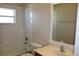 Clean bathroom featuring a tub and shower combination, window, and vanity with countertop at 537 Coral Trace Blvd, Edgewater, FL 32132