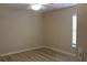 Neutral bedroom with wood-look flooring, ceiling fan, and window at 537 Coral Trace Blvd, Edgewater, FL 32132