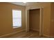 Light-filled bedroom with a window and closet with bifold doors and laminate flooring at 537 Coral Trace Blvd, Edgewater, FL 32132