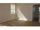 Well-lit bedroom with wood flooring and a view into the bathroom at 537 Coral Trace Blvd, Edgewater, FL 32132