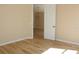 Open bedroom featuring wood floors and a doorway to another room at 537 Coral Trace Blvd, Edgewater, FL 32132
