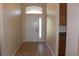 Bright entryway showcasing tile floors and a door with an arched window above at 537 Coral Trace Blvd, Edgewater, FL 32132