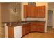 Spacious kitchen featuring wood cabinets, tile flooring, and a breakfast bar at 537 Coral Trace Blvd, Edgewater, FL 32132