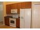Bright kitchen equipped with modern appliances and wood cabinets at 537 Coral Trace Blvd, Edgewater, FL 32132