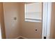 Compact laundry room with connections and window providing a functional space at 537 Coral Trace Blvd, Edgewater, FL 32132