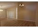 Open-concept living area with wood-look flooring and plenty of natural light at 537 Coral Trace Blvd, Edgewater, FL 32132