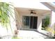 Covered patio with ceiling fan offering a shady retreat with access to the backyard and landscaping at 537 Coral Trace Blvd, Edgewater, FL 32132