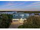Beautiful waterfront home with a lush landscaped yard, brick driveway, and attached garage at 73 Cunningham Dr, New Smyrna Beach, FL 32168