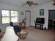 Bright living room featuring a ceiling fan, large TV, and comfy seating at 2325 Date Palm Dr, Edgewater, FL 32141