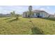 Large backyard featuring well-maintained lawn, partial fencing, and a screened-in lanai at 270 Eagle Harbor Way, Daytona Beach, FL 32124