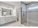 Modern bathroom featuring a glass-enclosed shower, double vanity with contemporary fixtures, and neutral tiling at 270 Eagle Harbor Way, Daytona Beach, FL 32124