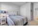 Cozy bedroom featuring a comfortable bed with striped bedding, a nightstand with a lamp, and neutral walls at 270 Eagle Harbor Way, Daytona Beach, FL 32124
