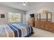 Large bedroom featuring a bed, dressers, a ceiling fan, and a window with natural light at 270 Eagle Harbor Way, Daytona Beach, FL 32124