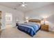 Bright bedroom showcasing a bed with striped bedding, wooden nightstands with lamps, and an ensuite bathroom at 270 Eagle Harbor Way, Daytona Beach, FL 32124