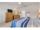 Spacious bedroom with neutral walls featuring a bed, dresser, mirror, ceiling fan, and ample natural light at 270 Eagle Harbor Way, Daytona Beach, FL 32124