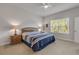 Bright bedroom featuring a bed, nightstands with lamps, a ceiling fan, and a large window with natural light at 270 Eagle Harbor Way, Daytona Beach, FL 32124