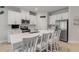 Bright kitchen boasts white cabinets, stainless steel appliances, and a center island with seating for casual dining at 270 Eagle Harbor Way, Daytona Beach, FL 32124