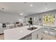 Open-concept kitchen featuring a white countertop island, stainless steel appliances, and seamless flow to the living area at 270 Eagle Harbor Way, Daytona Beach, FL 32124