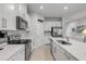 Modern kitchen featuring stainless steel appliances, white cabinetry, and a spacious island with seating at 270 Eagle Harbor Way, Daytona Beach, FL 32124
