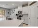 Chic kitchen with modern appliances, white cabinets, and a view of the dining area and backyard at 270 Eagle Harbor Way, Daytona Beach, FL 32124
