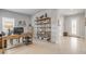Bright home office with a desk, shelving unit displaying decorative items, tile flooring, and natural light at 270 Eagle Harbor Way, Daytona Beach, FL 32124