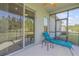 Enclosed back patio with a comfortable lounge chair and a view of the grassy backyard at 270 Eagle Harbor Way, Daytona Beach, FL 32124
