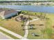Playground near lake featuring a variety of play structures and seating areas at 270 Eagle Harbor Way, Daytona Beach, FL 32124