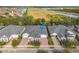 Aerial view of townhomes showing rooflines, landscaping, and brick driveways at 3331 Torre Blvd, New Smyrna Beach, FL 32168