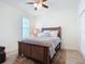 Bright bedroom is furnished with a wood bed frame, decorative bedside lamps, and a ceiling fan at 3331 Torre Blvd, New Smyrna Beach, FL 32168