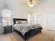 Comfortable main bedroom featuring a ceiling fan, two windows, and a large bed with matching furniture at 3331 Torre Blvd, New Smyrna Beach, FL 32168