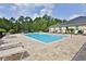 Inviting pool area with ample lounging space and black metal fence at 3331 Torre Blvd, New Smyrna Beach, FL 32168