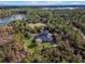 Aerial view showcasing the house's serene location near a lake and lush greenery at 335 Woodridge Dr, Geneva, FL 32732