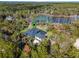 Aerial view showing home's location on a wooded lot near a lake at 335 Woodridge Dr, Geneva, FL 32732