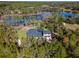 Aerial view showcasing house, pool, and surrounding tranquil landscape at 335 Woodridge Dr, Geneva, FL 32732