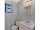 Small bathroom with white vanity, toilet, and mirror at 335 Woodridge Dr, Geneva, FL 32732