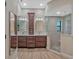 Elegant bathroom boasts double vanity and glass shower at 335 Woodridge Dr, Geneva, FL 32732