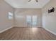 Bright bedroom with wood-look flooring and sliding doors at 335 Woodridge Dr, Geneva, FL 32732