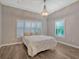 Spacious bedroom with plush bedding, large windows, and wood-look floors at 335 Woodridge Dr, Geneva, FL 32732