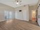 Primary bedroom with wood flooring and barn doors leading to bathroom at 335 Woodridge Dr, Geneva, FL 32732