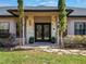 Elegant entryway with double doors and stone accents at 335 Woodridge Dr, Geneva, FL 32732