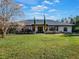 Elegant stone facade, two-story home with manicured lawn at 335 Woodridge Dr, Geneva, FL 32732