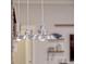 Modern pendant lights illuminate the kitchen at 335 Woodridge Dr, Geneva, FL 32732