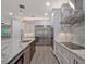 Modern kitchen with stainless steel appliances, marble countertops, and white cabinets at 335 Woodridge Dr, Geneva, FL 32732