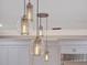 Pendant lights above kitchen island add a modern touch at 335 Woodridge Dr, Geneva, FL 32732