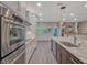 Modern kitchen with stainless steel appliances and marble countertops at 335 Woodridge Dr, Geneva, FL 32732